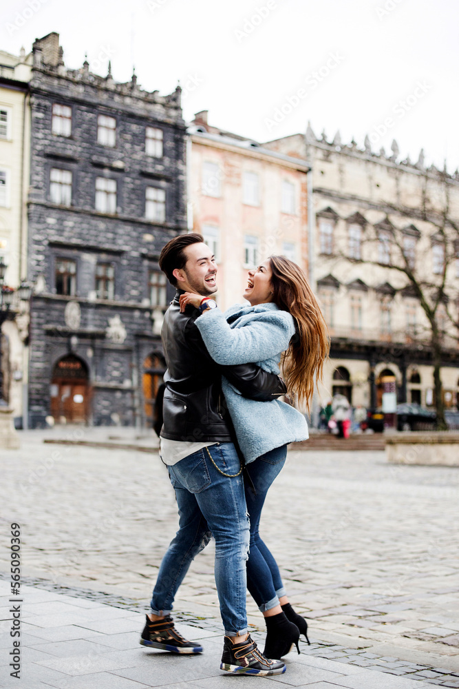 stylish happy couple enjoying a date on the street of a European city