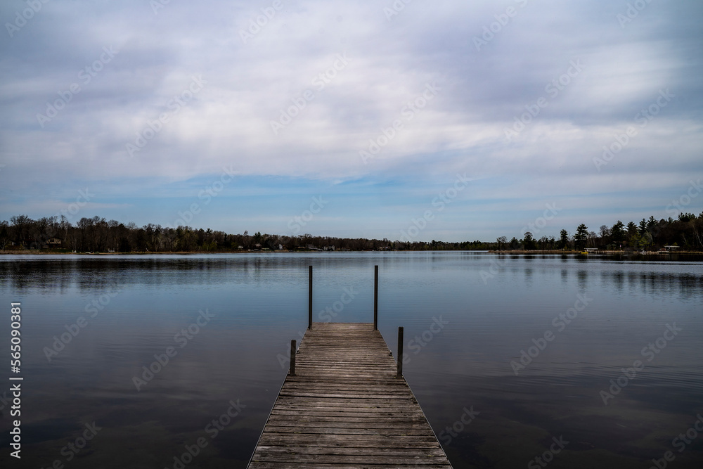 Wood Dock On Calm Lake on Cloudy Spring Day