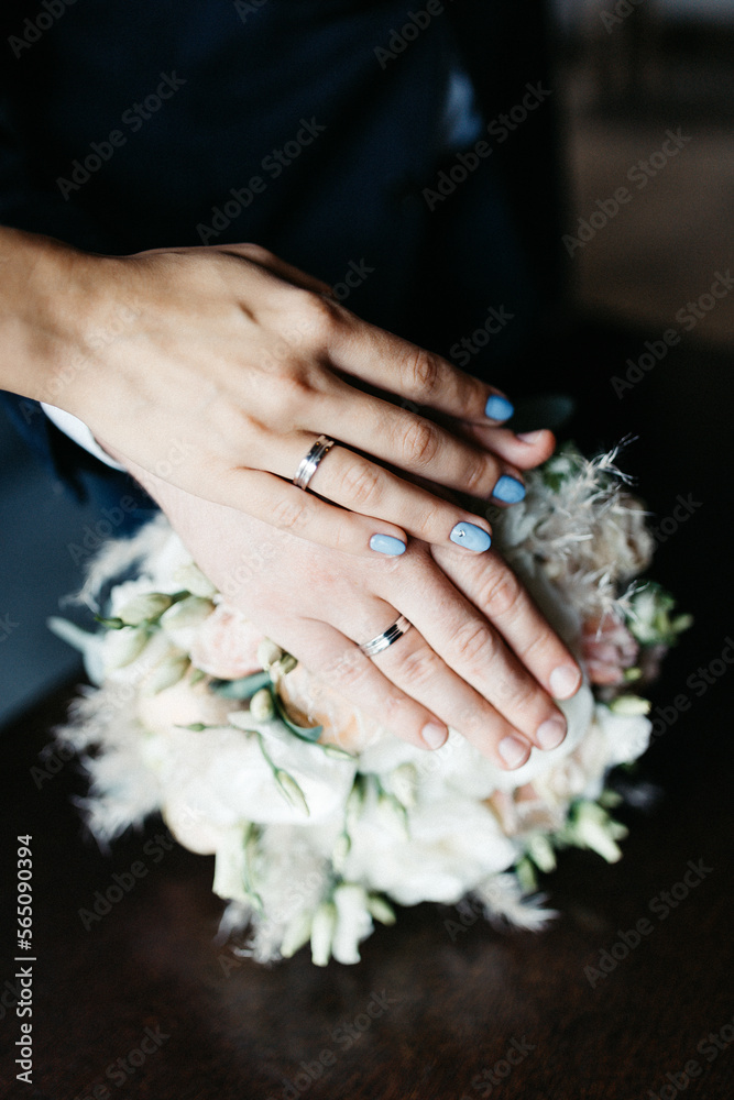Wedding couple in love holding hands on their wedding day Wedding couple in love holding hands on their wedding day