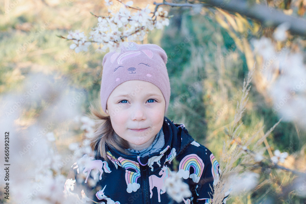 Portrait of a girl on the background of a spring flowering tree