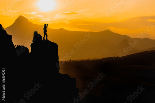 silhouette of mountaineer observing in the mountains