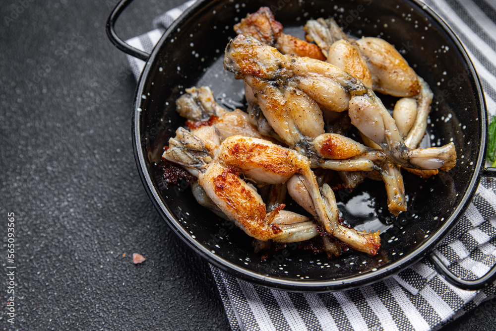 fried frog legs second course meat french food healthy meal food snack on the table copy space food background rustic top view fried frog legs second course meat french food healthy meal food snack on the table copy space food background rustic top view