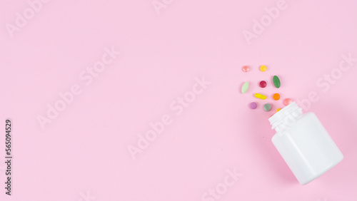 scattered pills on color background, top view. Space for text the left © Igor Starodubtsev