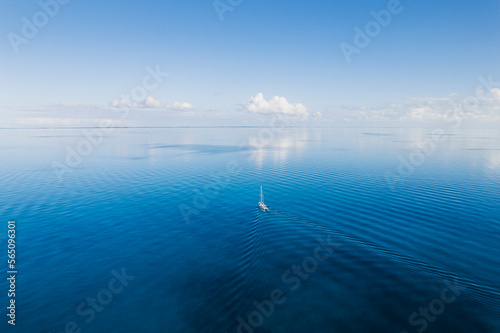 Aerial of Sailboat in Flat Calm Seas in the Bahamas photo