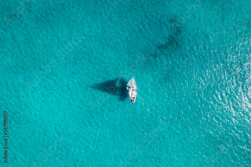 Aerial of Sailboat Sailing Through Turquoise Bahamas Waters photo