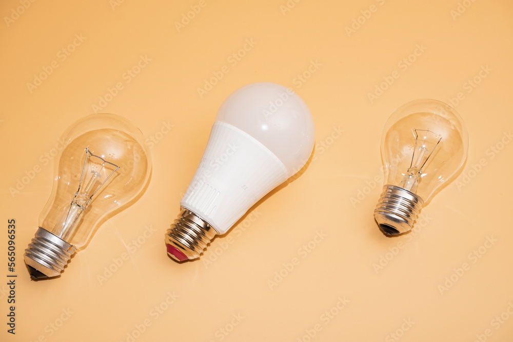 Electric light bulbs. energy efficiency concept. LED lamp vs incandescent lamp. Composition on a yellow background. Use economical light bulbs. Electric light bulbs. energy efficiency concept. LED lamp vs incandescent lamp. Composition on a yellow background. Use economical light bulbs.