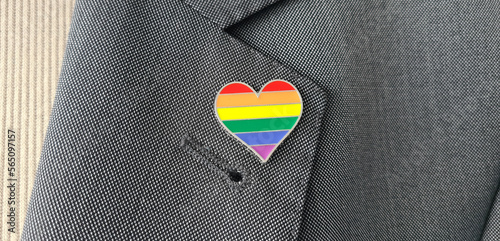 Obraz na plátne Metal badge with lgbt flag on lapel of man or woman suit