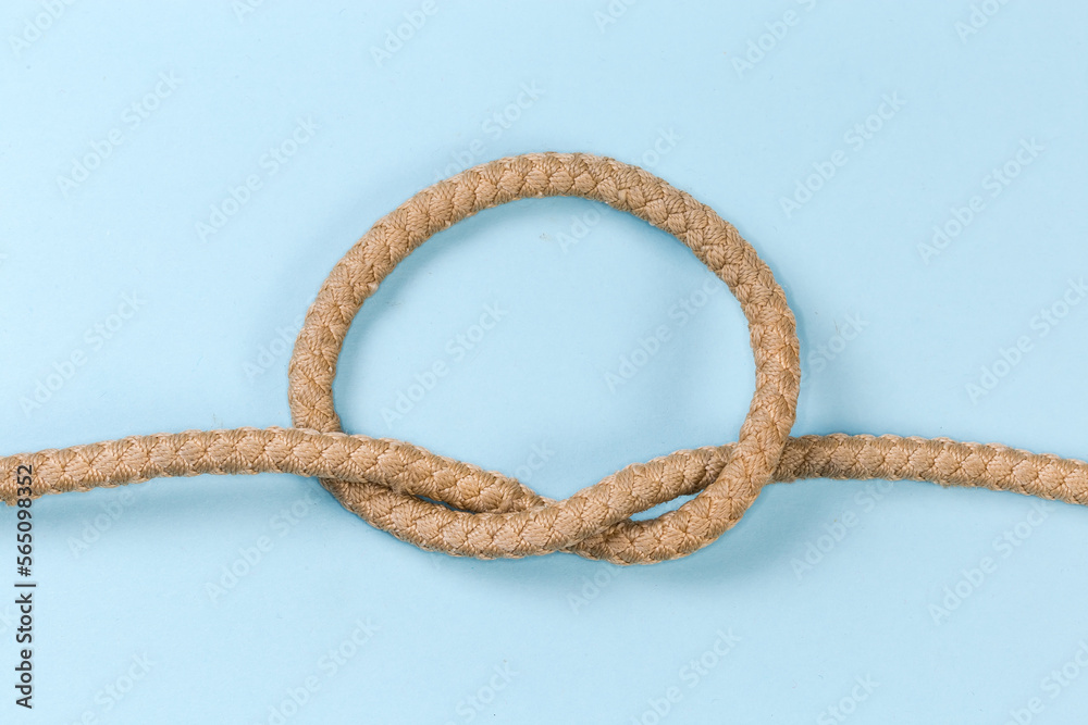 Rope knot as overhand knot on a blue background