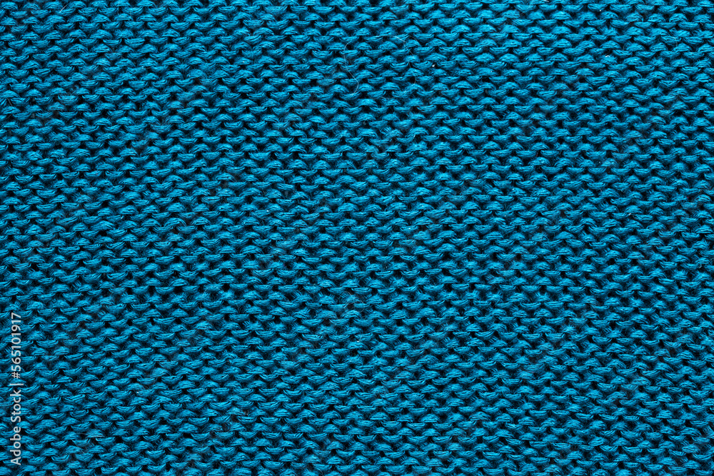 Background of knitted fabric with a pattern. Weaving winter clothes close-up. Background of knitted fabric with a pattern. Weaving winter clothes close-up.