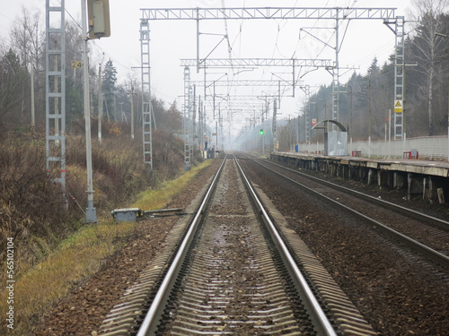 railway in the village near Moscow in autumn, rails and poles with infrastructure