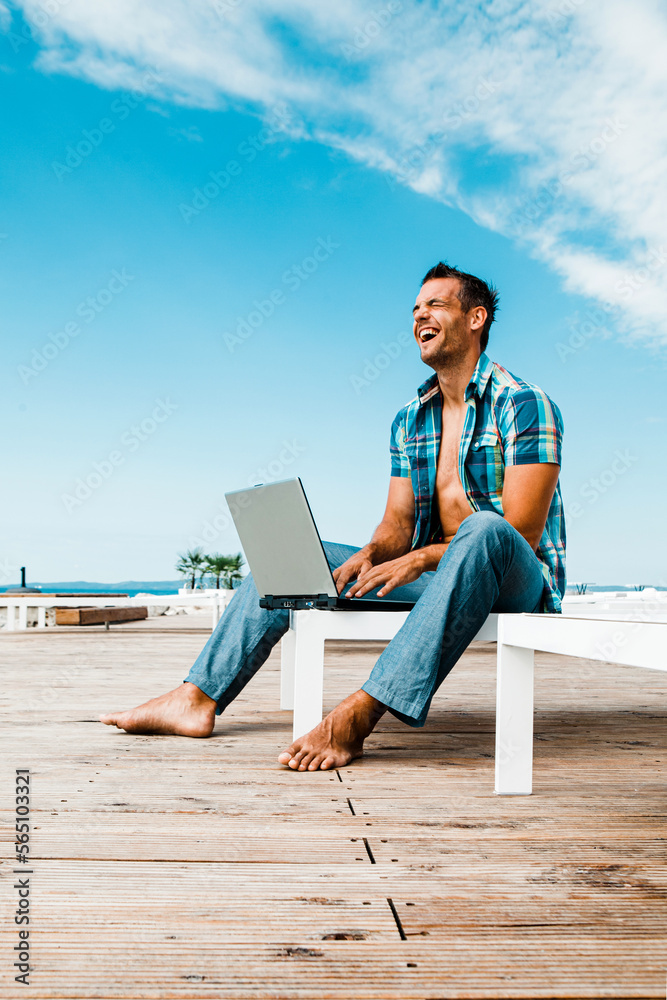 Man with the laptop on the modern beach resort 