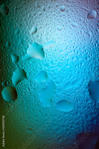 Abstract background. Abstract blurred image of colored soft gradients through wet glass. The texture of water drops on glass