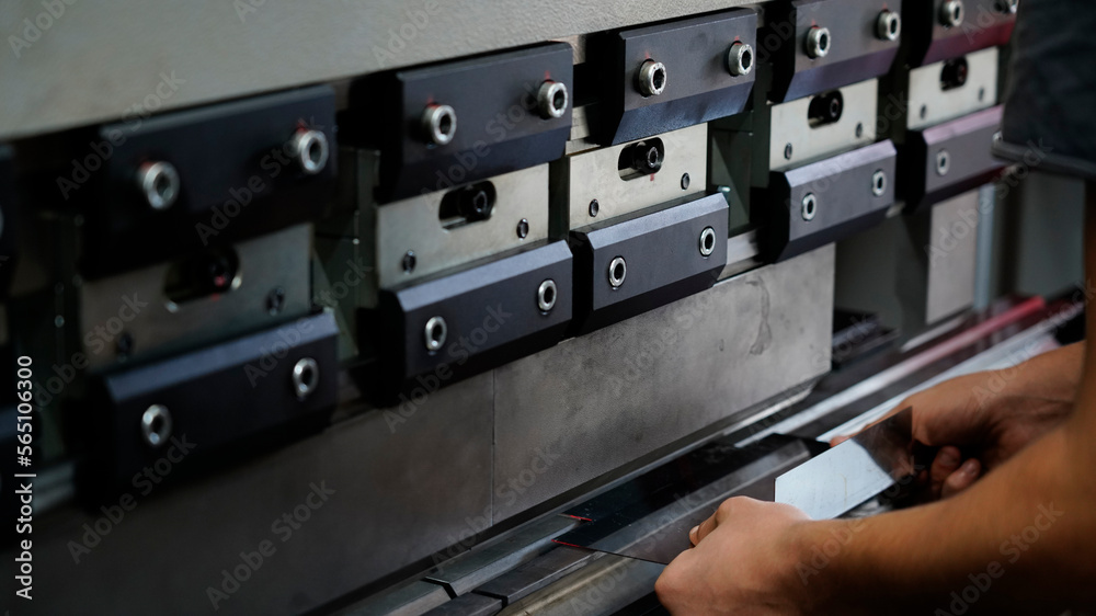 worker, pressing metal in press machine at factory worker, pressing metal in press machine at factory