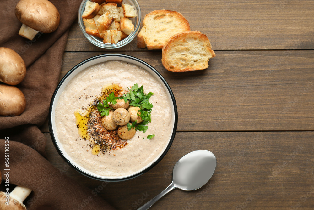 Delicious cream soup with mushrooms and ingredients on wooden table, flat lay. Space for text Delicious cream soup with mushrooms and ingredients on wooden table, flat lay. Space for text