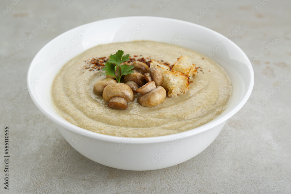 Delicious cream soup with mushrooms and croutons on beige textured table, closeup Delicious cream soup with mushrooms and croutons on beige textured table, closeup