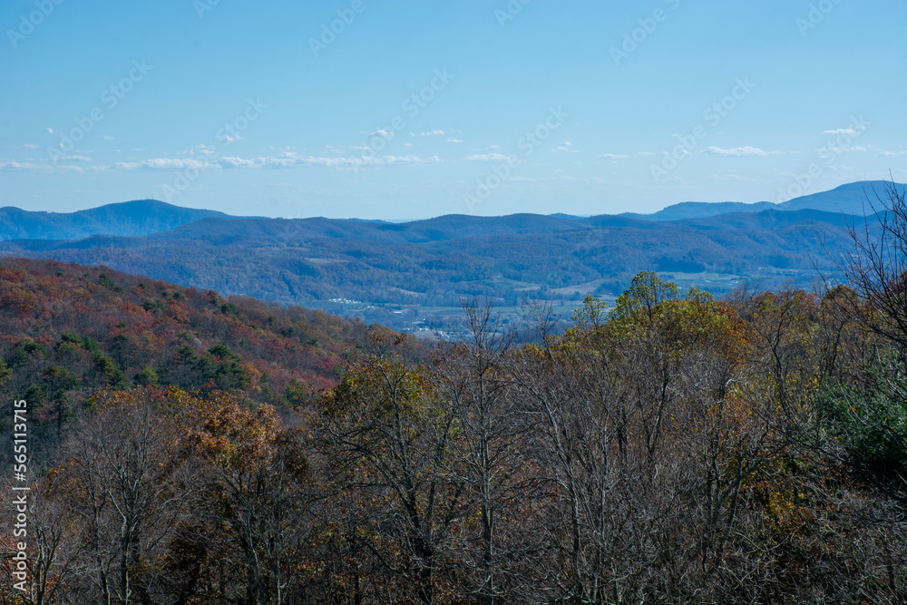 Blues of the Blue Ridge Mountains with fall colors and a small town in the distance