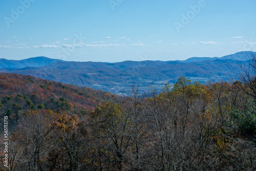 Blues of the Blue Ridge Mountains with fall colors and a small town in the distance