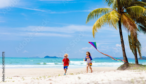 Child with kite. Kids play. Family beach vacation. © famveldman