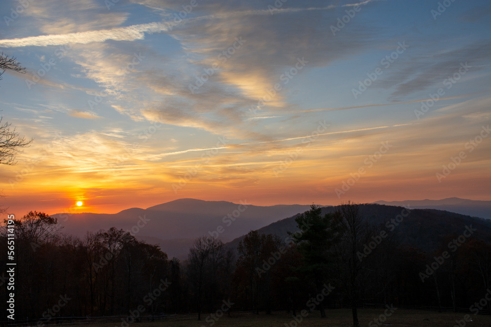 Sun rises fully above the mountains in the distance for a gorgeous Blue Ridge sunrise