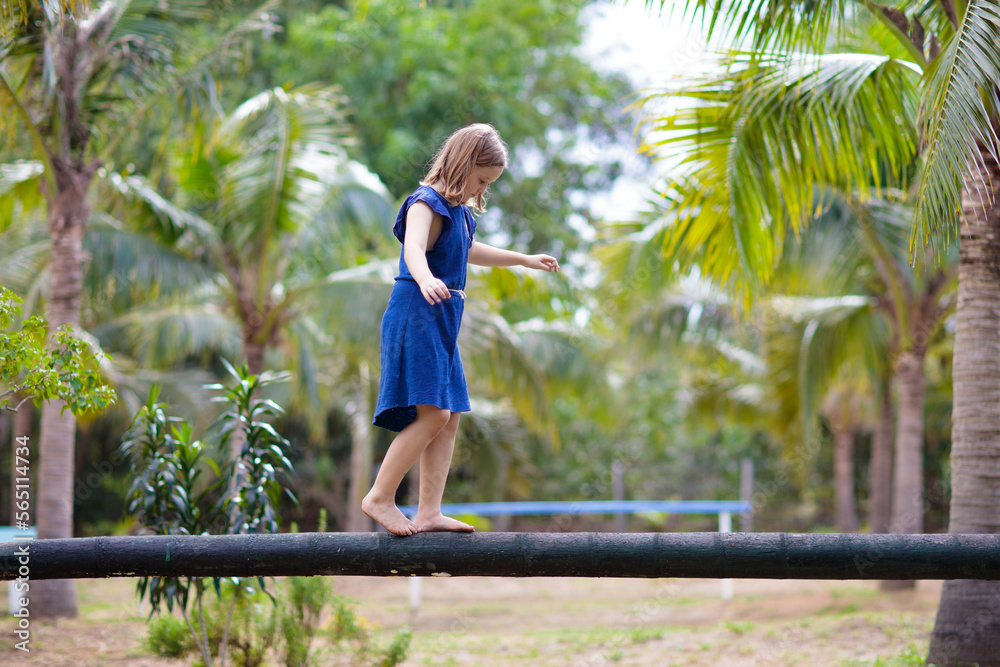 Kids on beam. Playground in tropical resort.