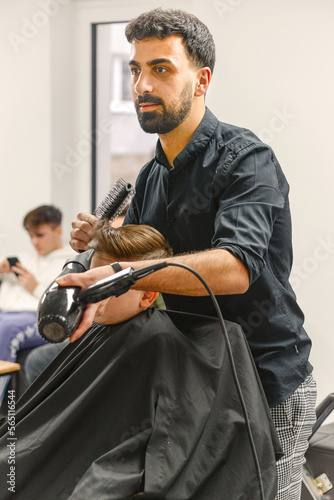 salon. close-up of a male haircut, the master does styling in a barbershop photo