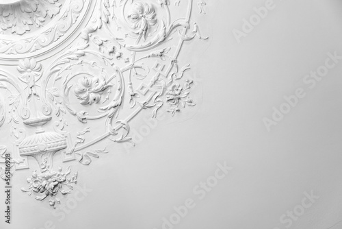 White gypsum bas-relief ceiling design elements in rococo style