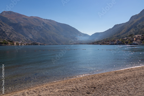 Idyllic beach in coastal town Prcanj with panoramic view of Kotor Bay  Adriatic Mediterranean Sea  Montenegro  Balkans  Europe. Fjord winding along mountain cliffs of Dinaric Alps. Vacation in summer