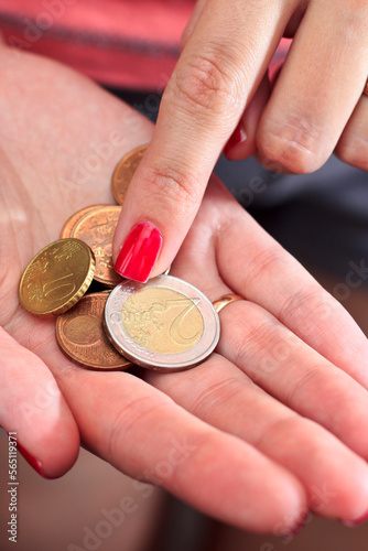 Counting coins in hand. Price increase.