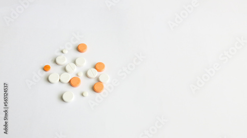 Assorted scattered pharmaceutical medicine pills and tablets in various colour and size isolated in white background, copy space for text or advertising