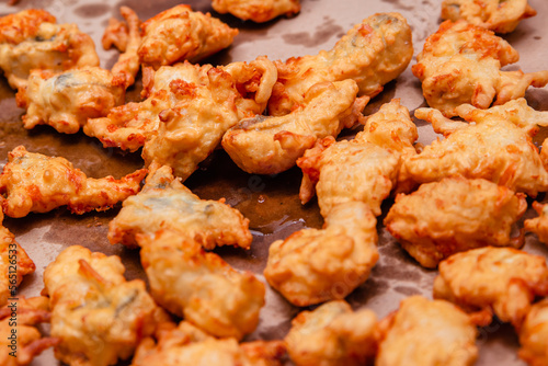 Fried chicken meat in oil dries on a sheet of paper. Fast food