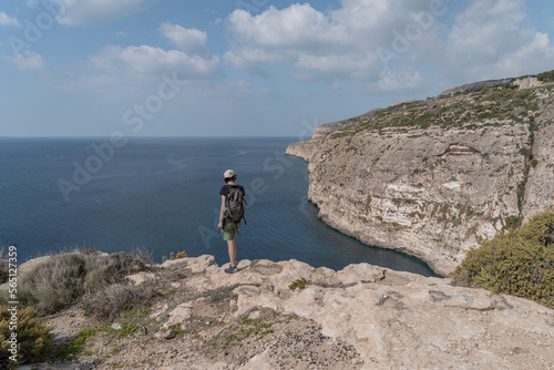 Man standing on the cliff watching the sea on a sunny summer day in Malta