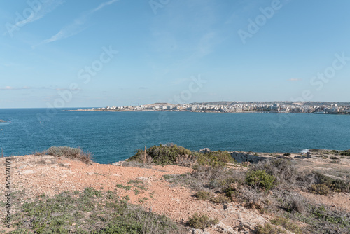 Panaromic view of brown rocks and light blue sea on a sunny summer day in Malta