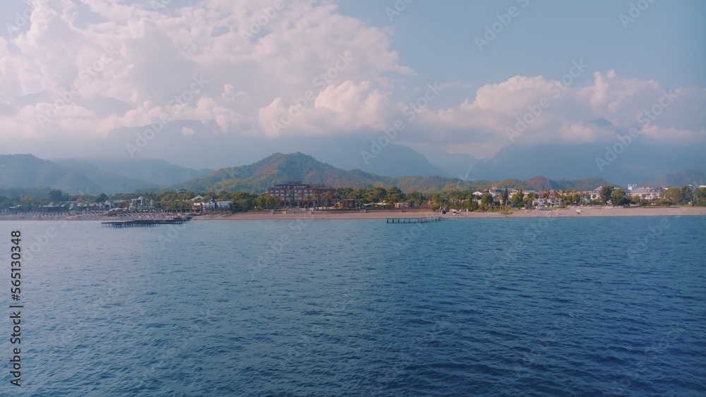 Panorama view of the blue sea. Beautiful clouds. Photography. Mountains in the background. Seascape.
