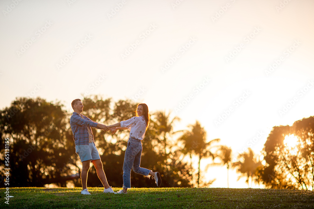 Fototapeta premium Family of two in the park on summer day outdoors