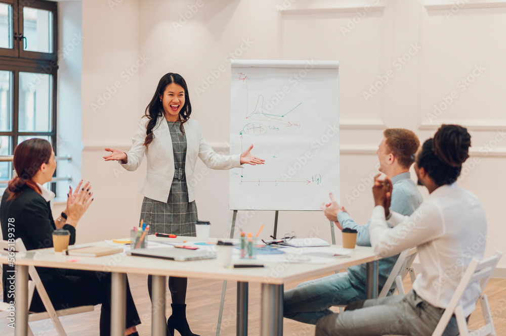 Asian businesswoman holding a meeting to his diverse colleagues in an office Asian businesswoman holding a meeting to his diverse colleagues in an office