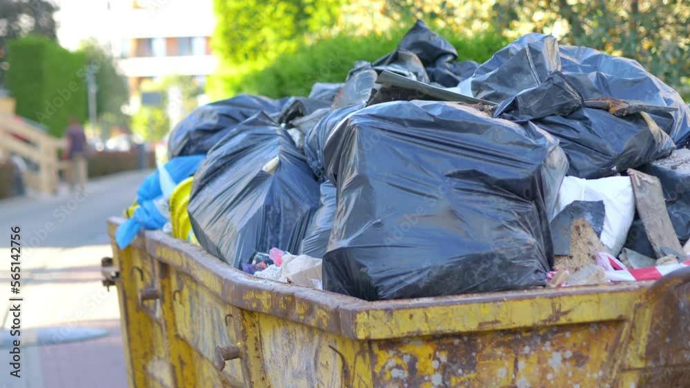 Overflowing Rag Container Overflowing garbage container on the street in 4k slow motion 60fps ...