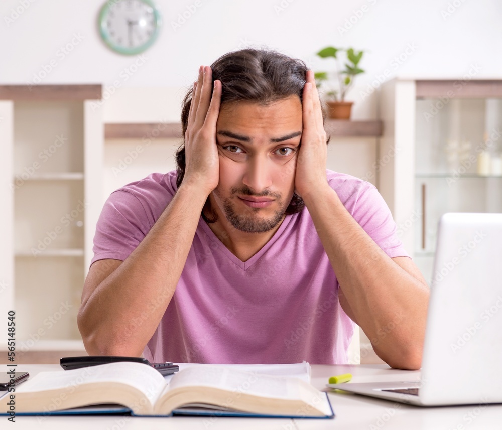 Young male student preparing for exams at home Young male student preparing for exams at home