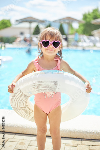 Wallpaper Mural child girl 3 years old swims in the pool in the summer outdoors Torontodigital.ca