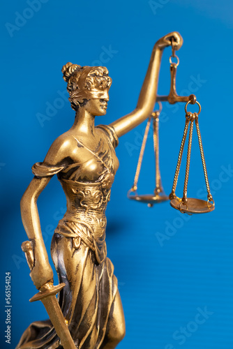 golden lady justice on blue background