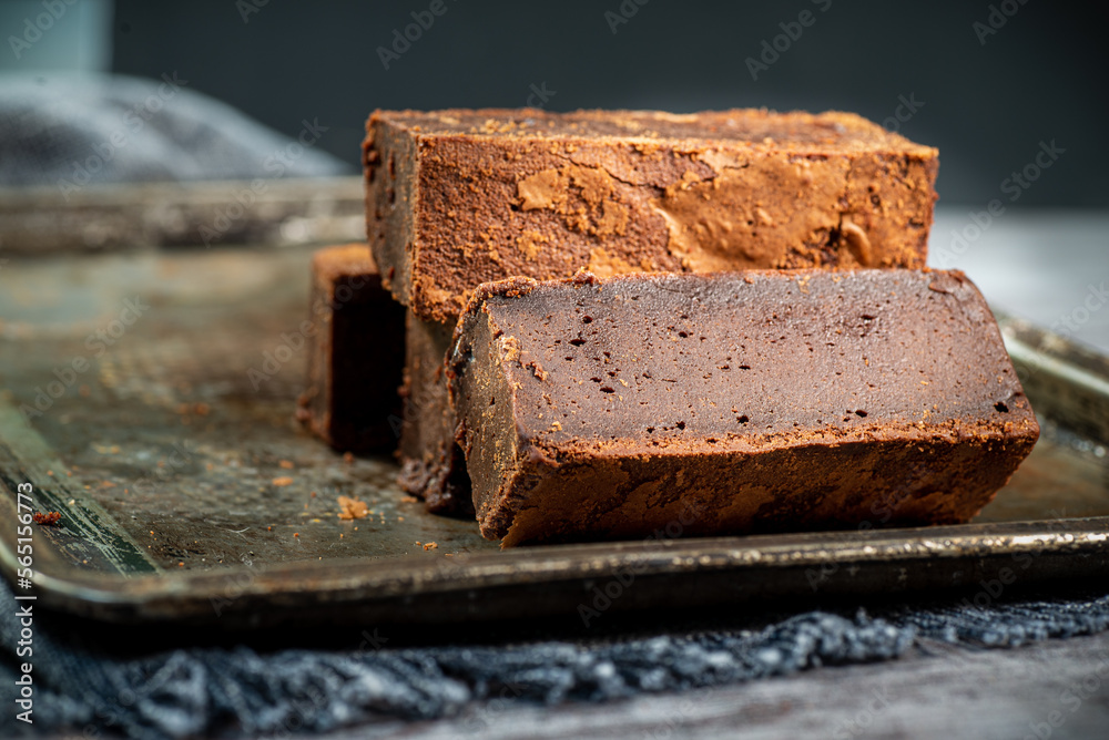 gluten free brownie, handmade, on baking tray, with gray background, macro close-up. gluten free brownie, handmade, on baking tray, with gray background, macro close-up.