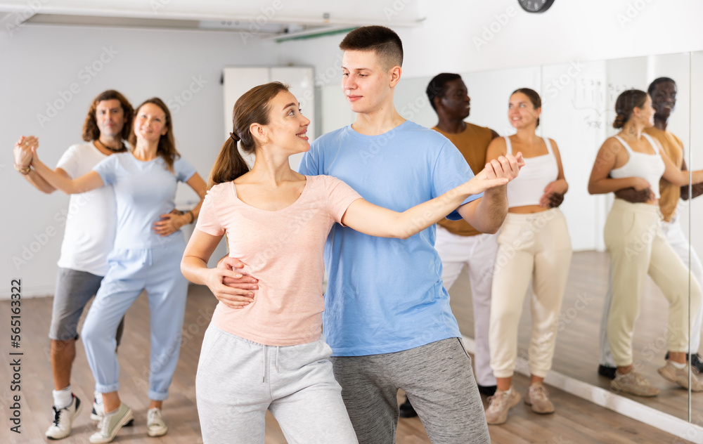 Young girl and teen boy dancing pair dance in dance hall