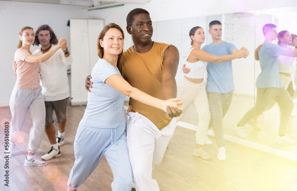Fototapeta premium Couple male and female rehearsing pair dance in dance studio