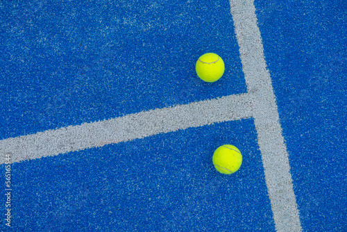 balls on a blue paddle tennis court © Vic
