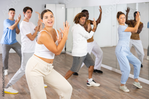 Group of international people dancing in gym with crossed hands. The concept of sport, dance and healthy lifestyle