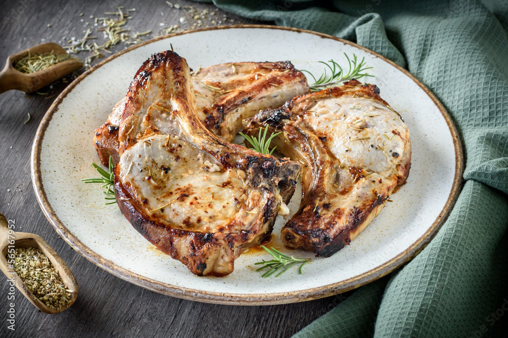 Juicy and served pork chops on the plate Juicy and served pork chops on the plate