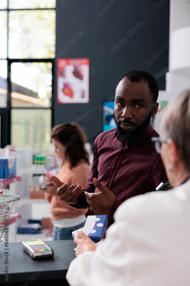 African american client asking pharmacist for help with medicaments prescription discussing health care treatment in pharmacy. Drugstore worker offering support assistance to clients, medicine service African american client asking pharmacist for help with medicaments prescription discussing health care treatment in pharmacy. Drugstore worker offering support assistance to clients, medicine service