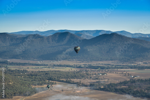 Enjoying travelling with hot air balloon in the clear blue sunrise morning sky for family gathering and school holiday travel destination