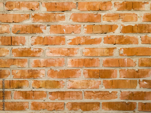 Colored vector texture of an old brick wall. Original illustration of a red brick wall for a designer. Close-up of a wall of carelessly laid bricks