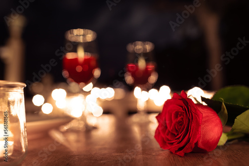 closeup of rose on table Valentine's dinner date night setting 