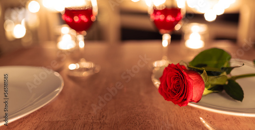 Closeup of rose in a Romantic candle light dinner setting.	